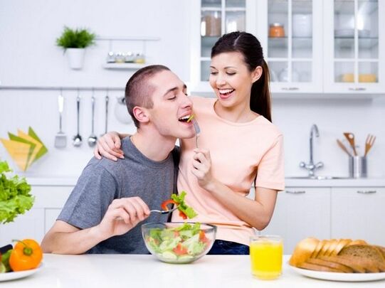 a woman feeds a man with products to increase natural activity