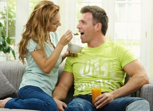 a woman nourishes a man with products to increase activity